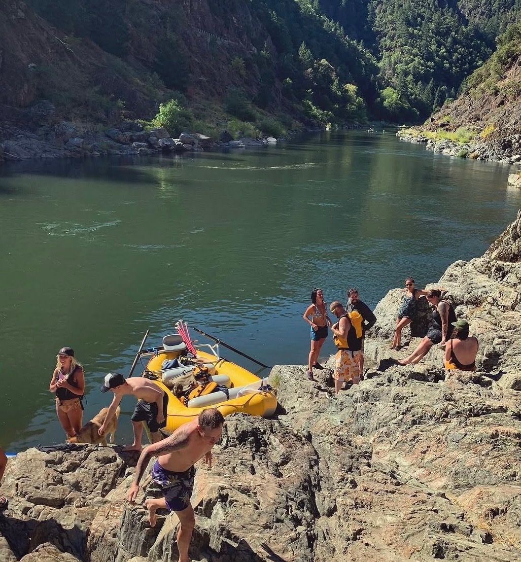 Guests on the rocks beside a raft in Hellgate Canyon